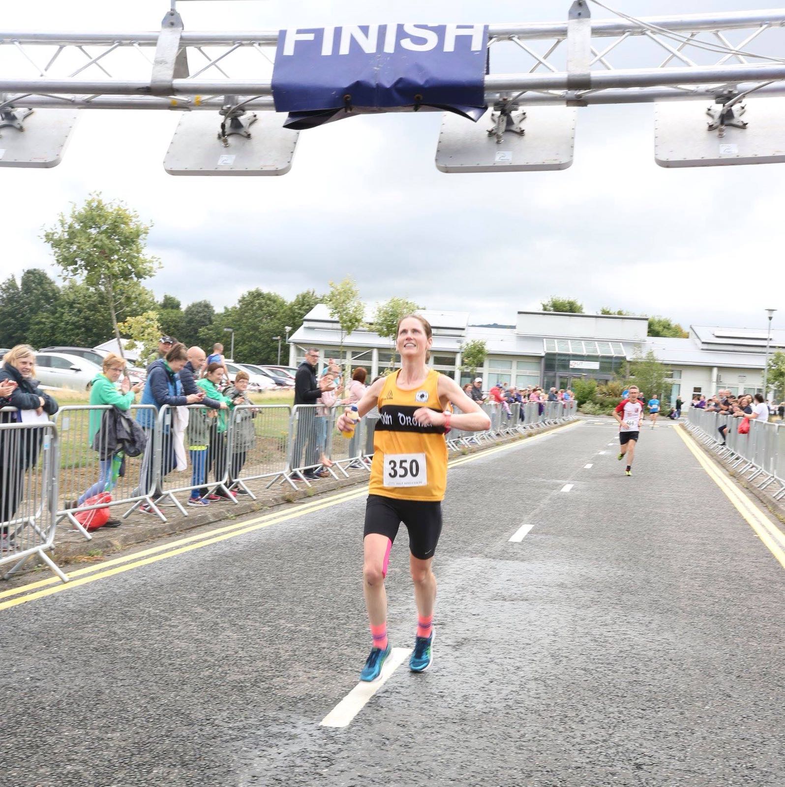 Linda Grogan crossing the finish line to win 1st Lady at the Boston Scientific Half Marathon.